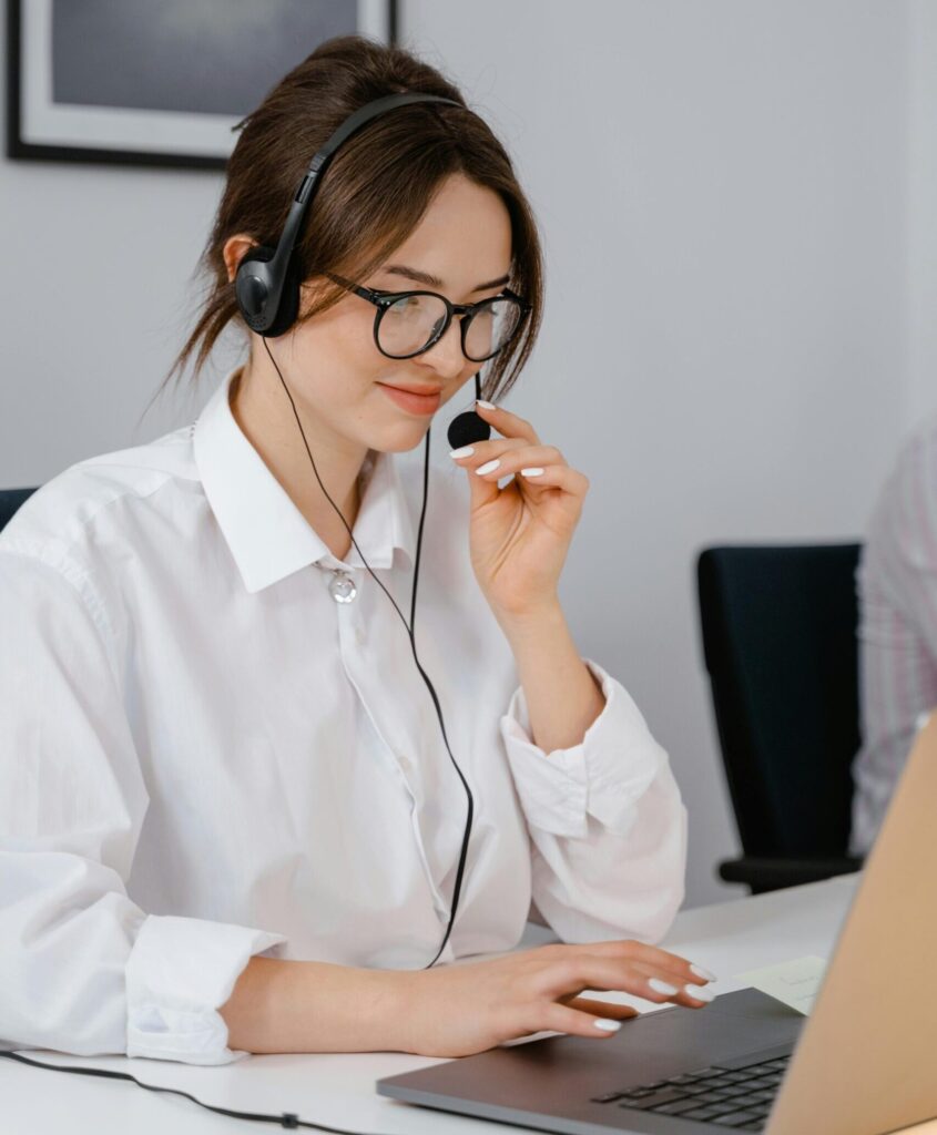 Professional woman using headset for customer service in office setting.